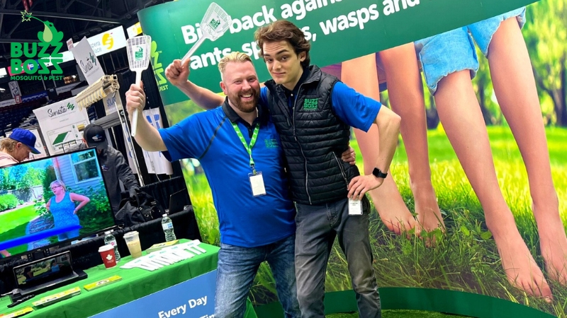 Buzz Boss employees at a convention holding fly swats
