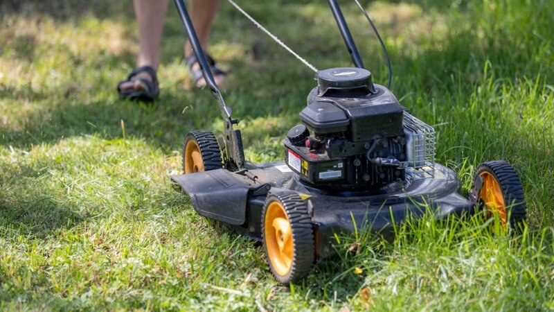 Lawn mower cutting grass to a perfect length to keep mosquitos away